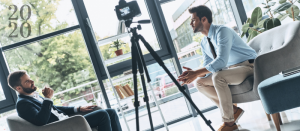 Two men in front of a camera.
